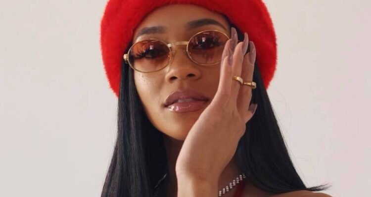 Saweetie press photo with red hat