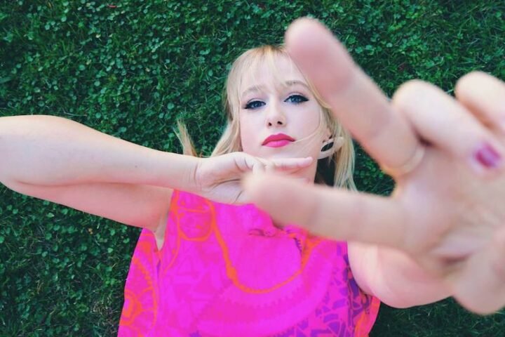 MAWD is laying down on green grass