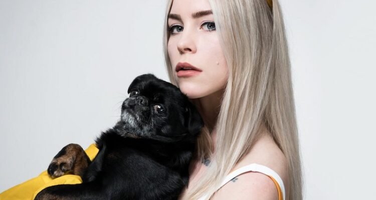 SHY Martin press photo holding a dog
