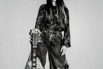 Gina Brooklyn press photo with guitar
