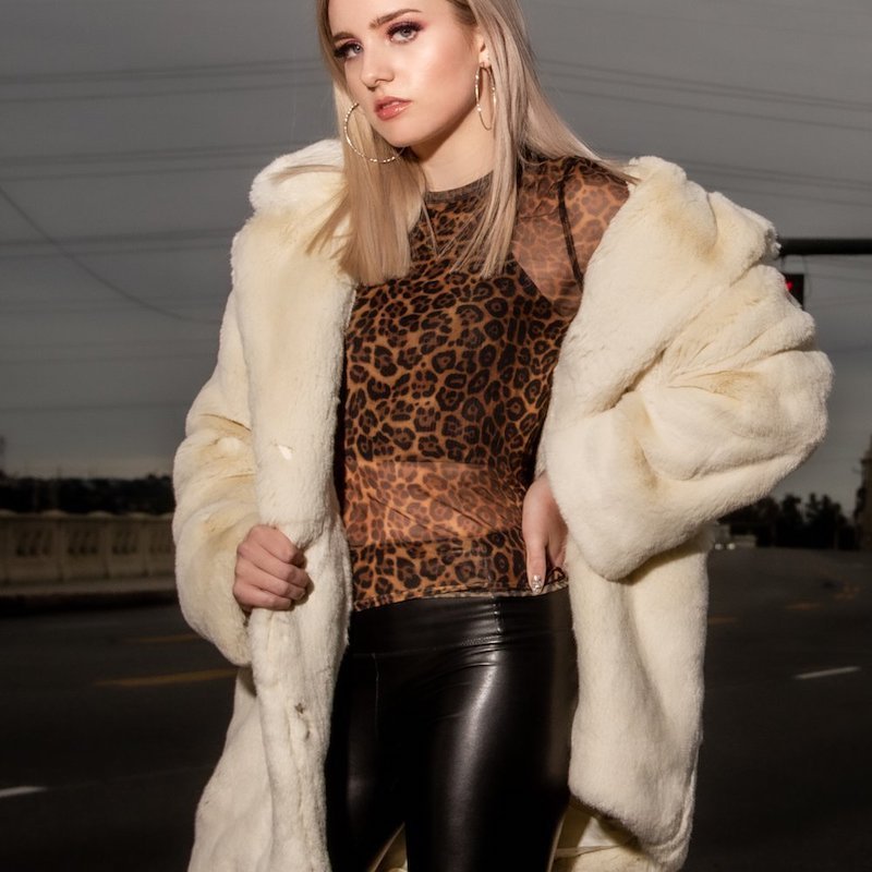 Rayne press photo wearing a fur coat