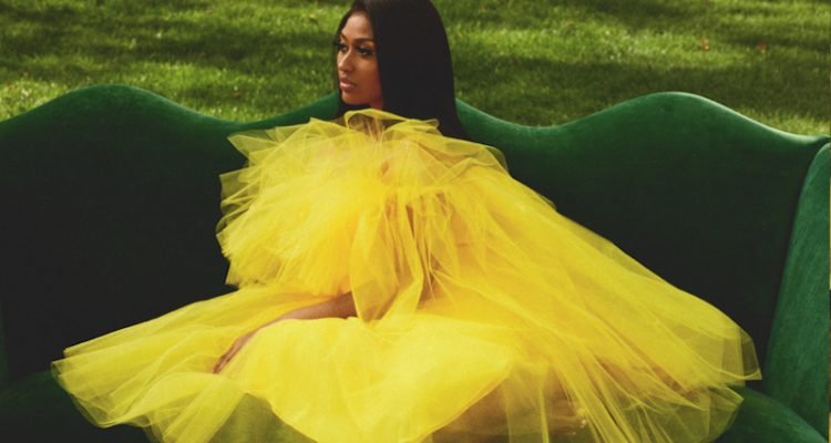 Jazmine Sullivan - “Girl Like Me” cover press photo wearing a yellow dress.