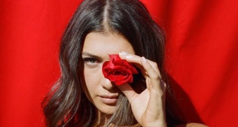 Leah Kate's "Boyfriend" press photo with a rose covering her left eye.
