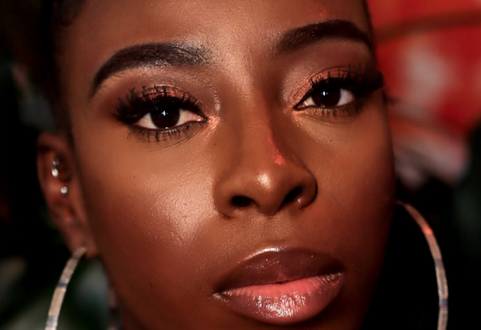 Zenesoul press photo wearing loopy earrings (close up)