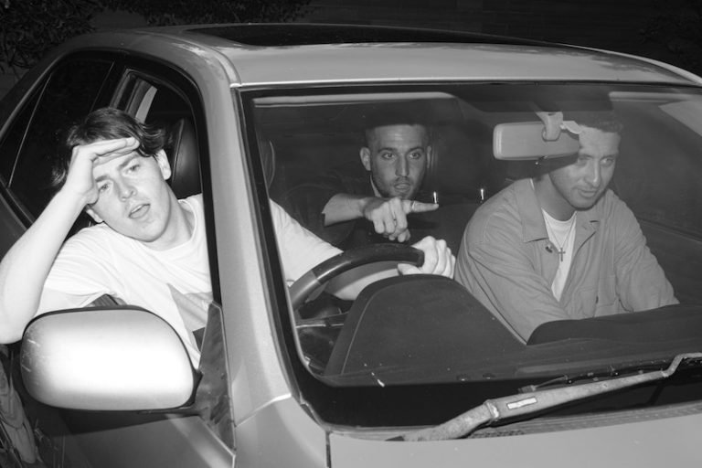 daste. sitting inside of a car (black and white photo).