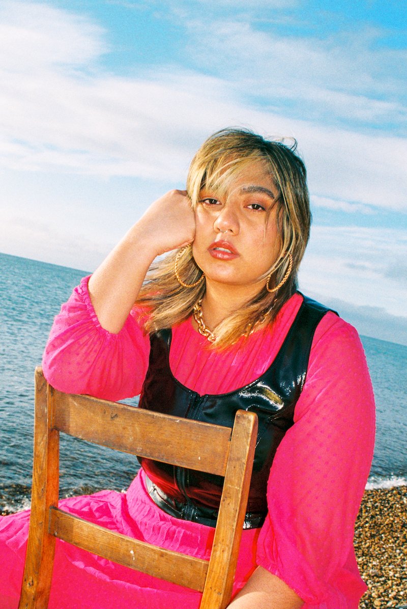 Kaisha - “Predicament” press photo outside with a large body of water in the background