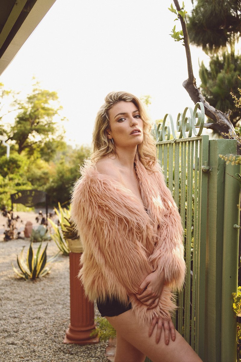 Lola Lennox WYG press photo outside wearing a stylish pink coat