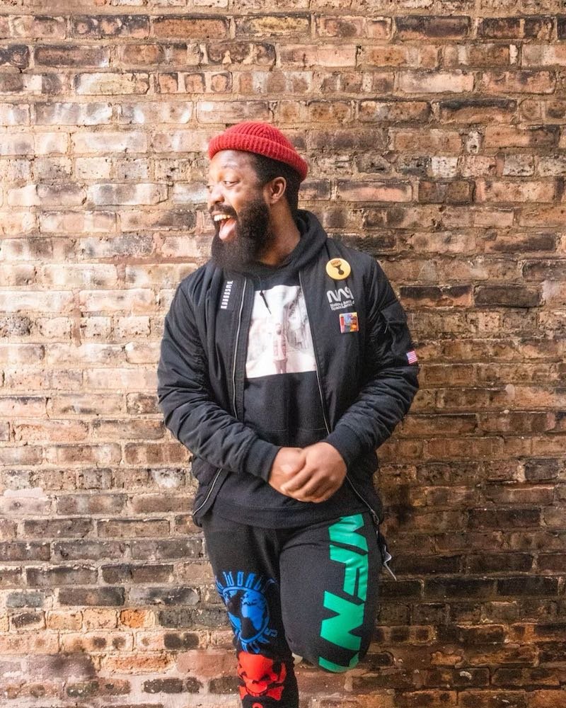 Neak press photo in front of a brick wall