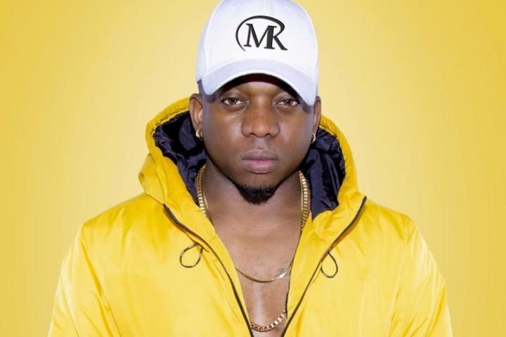 DJ Mike Klaw press photo wearing a yellow hoodie coat
