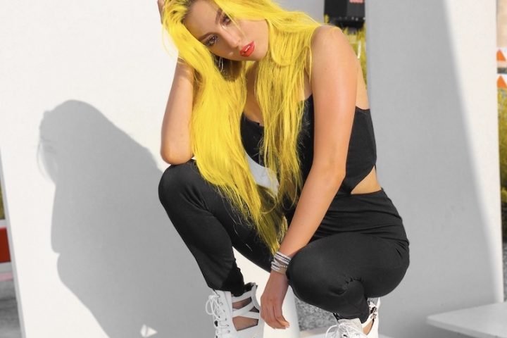 KINGS press photo with yellow hair and black outfit