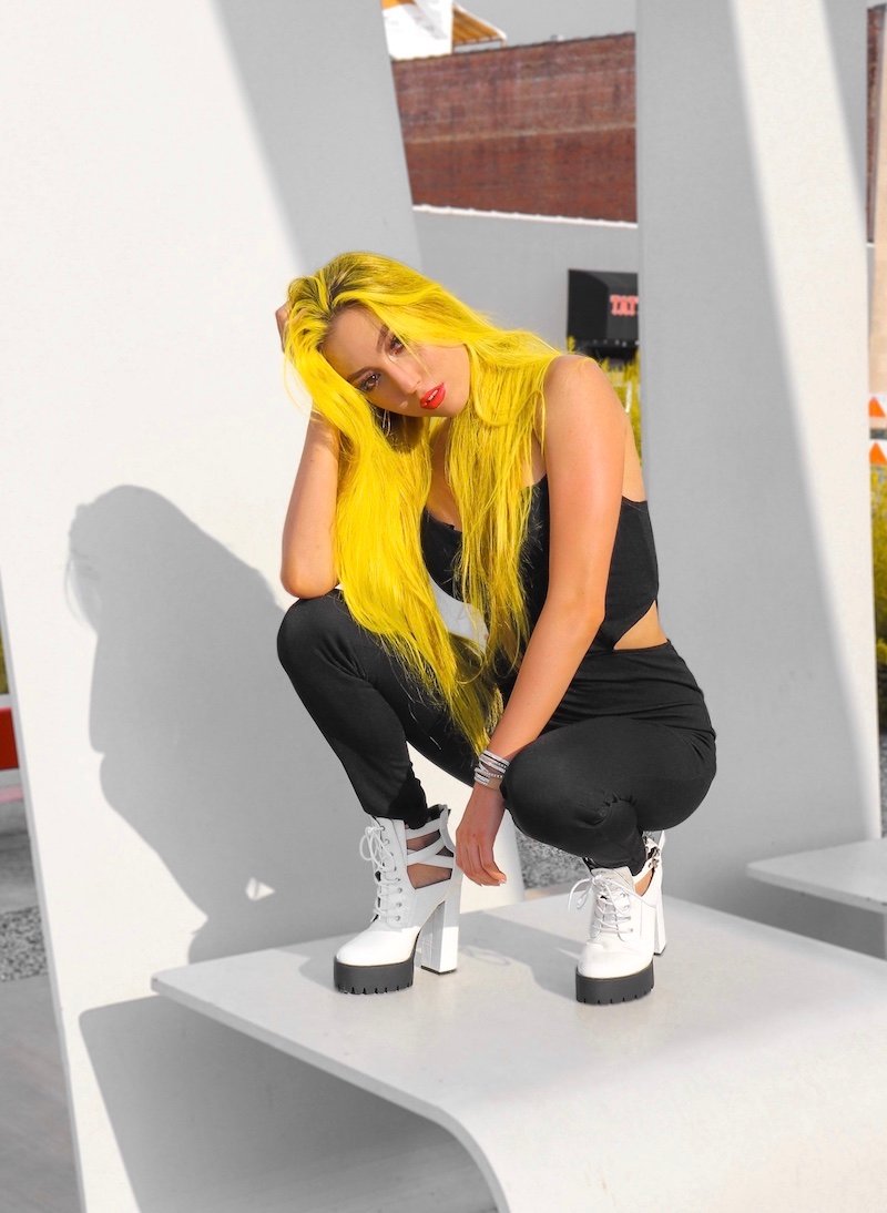 KINGS press photo with yellow hair and black outfit