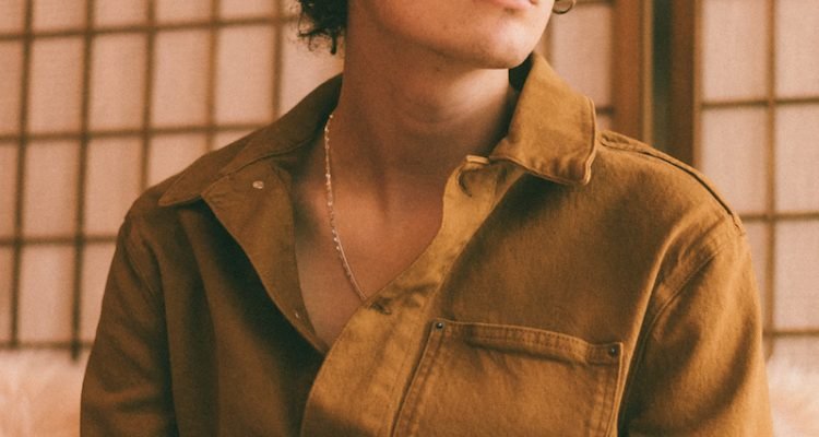 ASTN press photo wearing a brown shirt