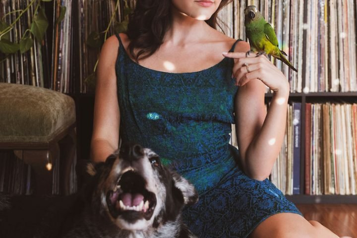 Monica Aben press photo with a dog and bird