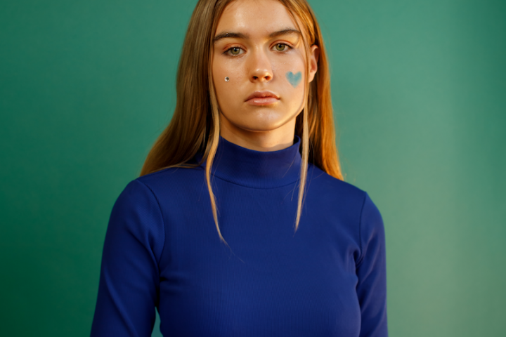 Paula Jivén press photo wearing a blue turtleneck sweater