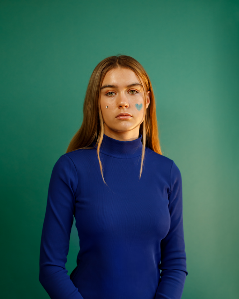 Paula Jivén press photo wearing a blue turtleneck sweater