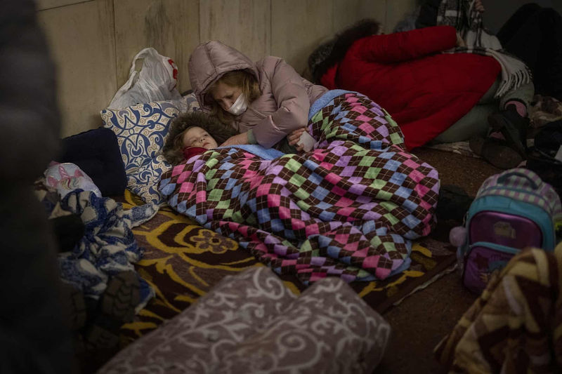 In Ukraine, Woman and child sleeping in safe zone. 
