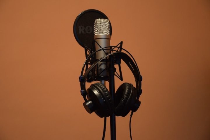 Photo of a microphone, headphones, and a music mic