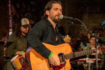 Eric Lee press photo on stage performing