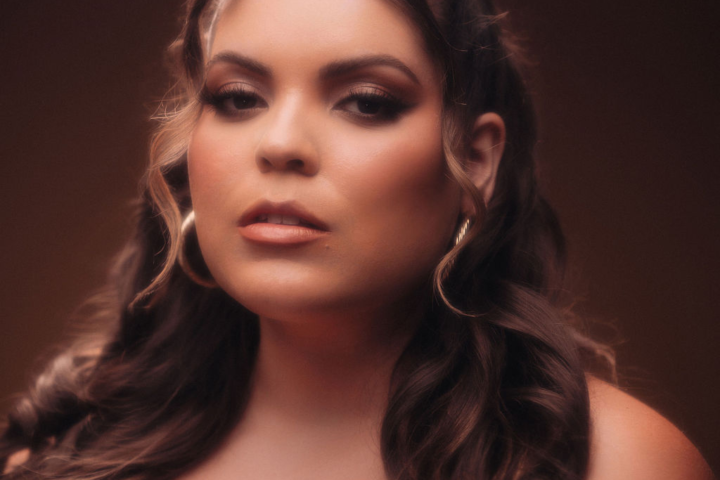 Elle Baez Different Kind of Love press photo with the artist staring deeply at her audience