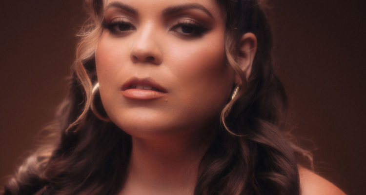 Elle Baez Different Kind of Love press photo with the artist staring deeply at her audience