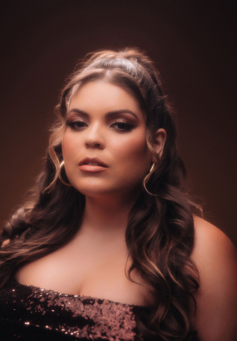 Elle Baez Different Kind of Love press photo with the artist staring deeply at her audience