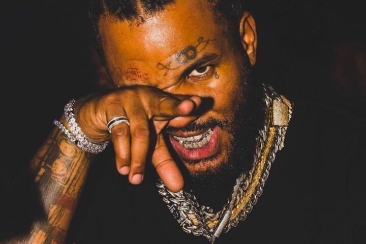 The Game press photo with black t-shirt and jewelry