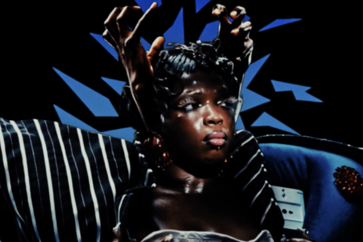 Theodora – Des mythos press photo with Black hands encaging the artist head